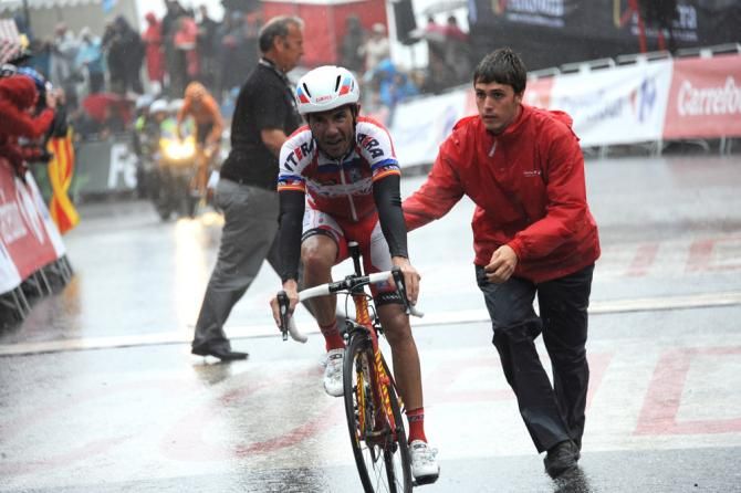 Joaquim Rodriguez (Katusha) is assisted at the finish line
