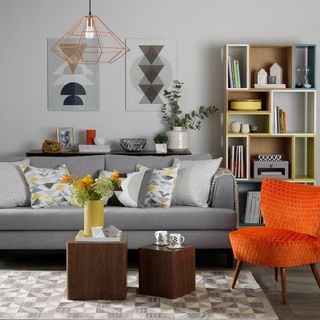 living room with geometric artwork and grey sofa