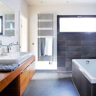 bathroom with grey tiles floor and white basin