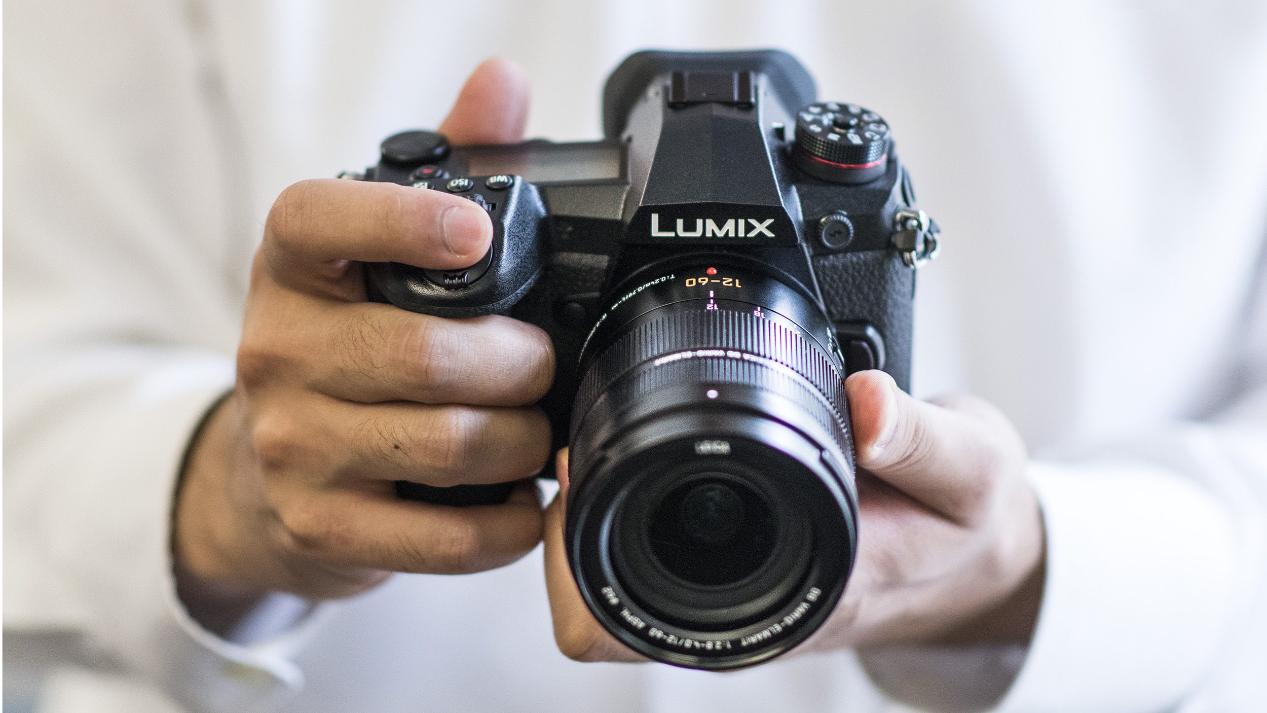 The Panasonic Lumix G9 being held with two hands