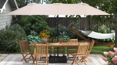 an outdoor picnic table with a large umbrella