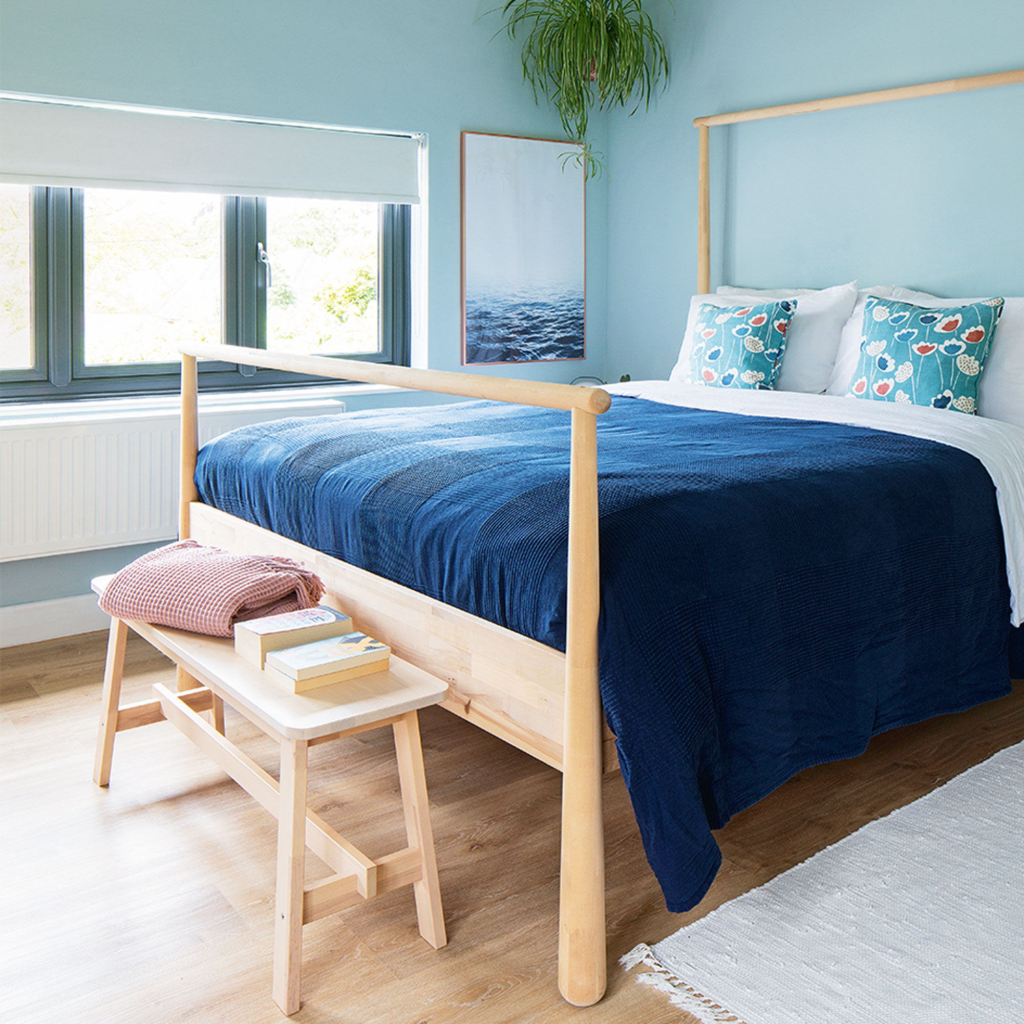 green bedroom with wooden bed