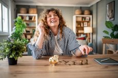 Happy woman with piggy bank, concept of bank switching offers 