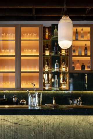 Thames Distillers new home and Fords bar, is an industrial gin brick distillery with a glamorous bar clad in green stone