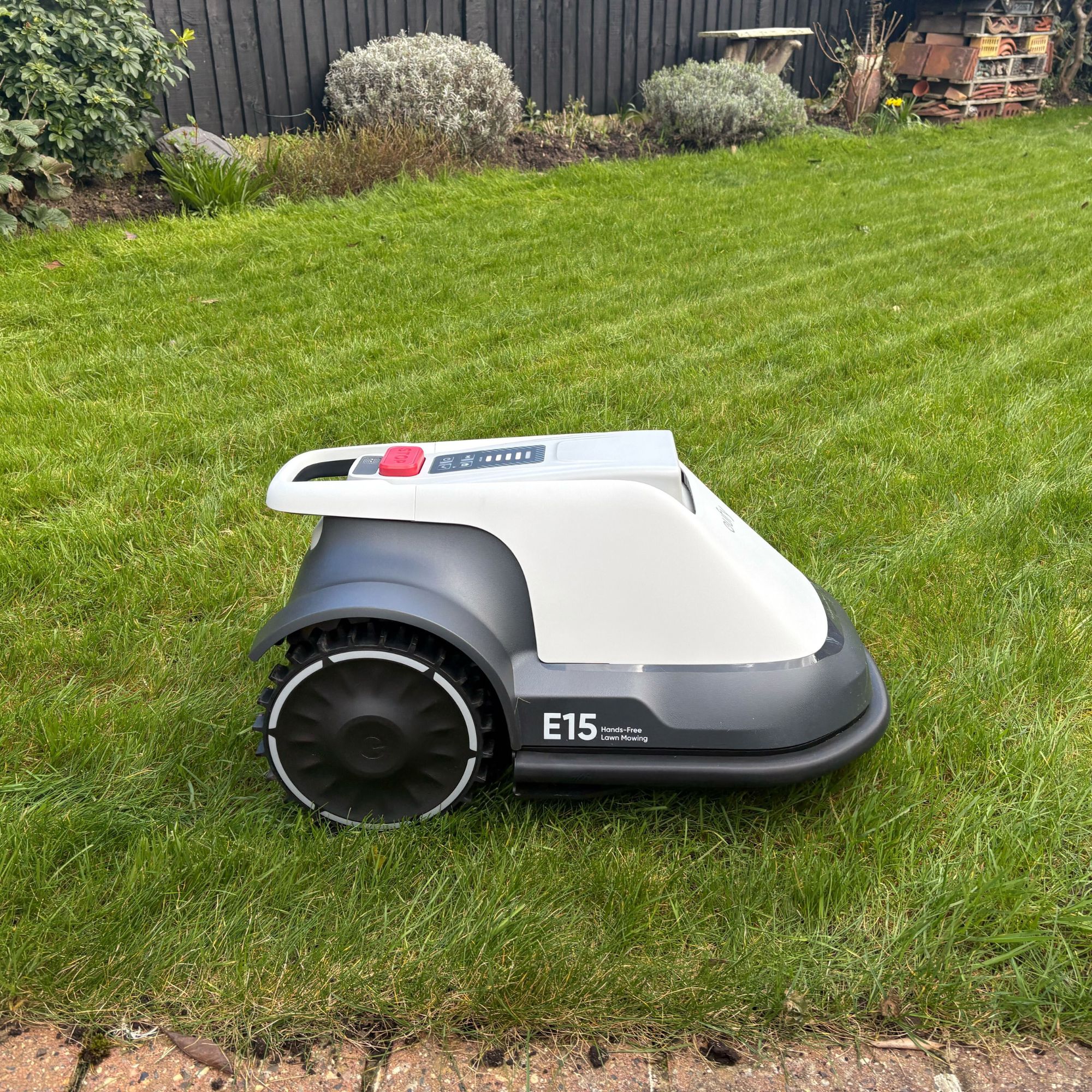 Side view Eufy E15 Robot Lawn Mower mowing grass lawn