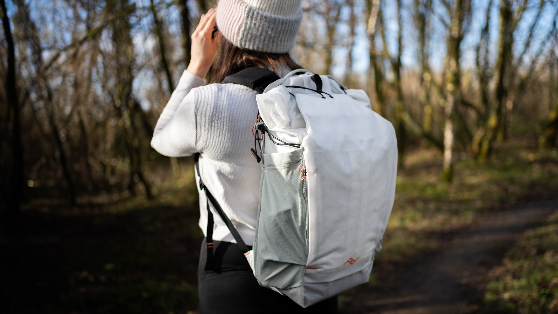 woman wearing the peak design outdoor bag in a nature reserve