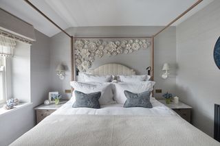 Small bedroom decorated in neutral colors with 4 poster bed