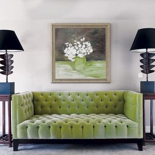 living room with green coloured sofa and two lamps