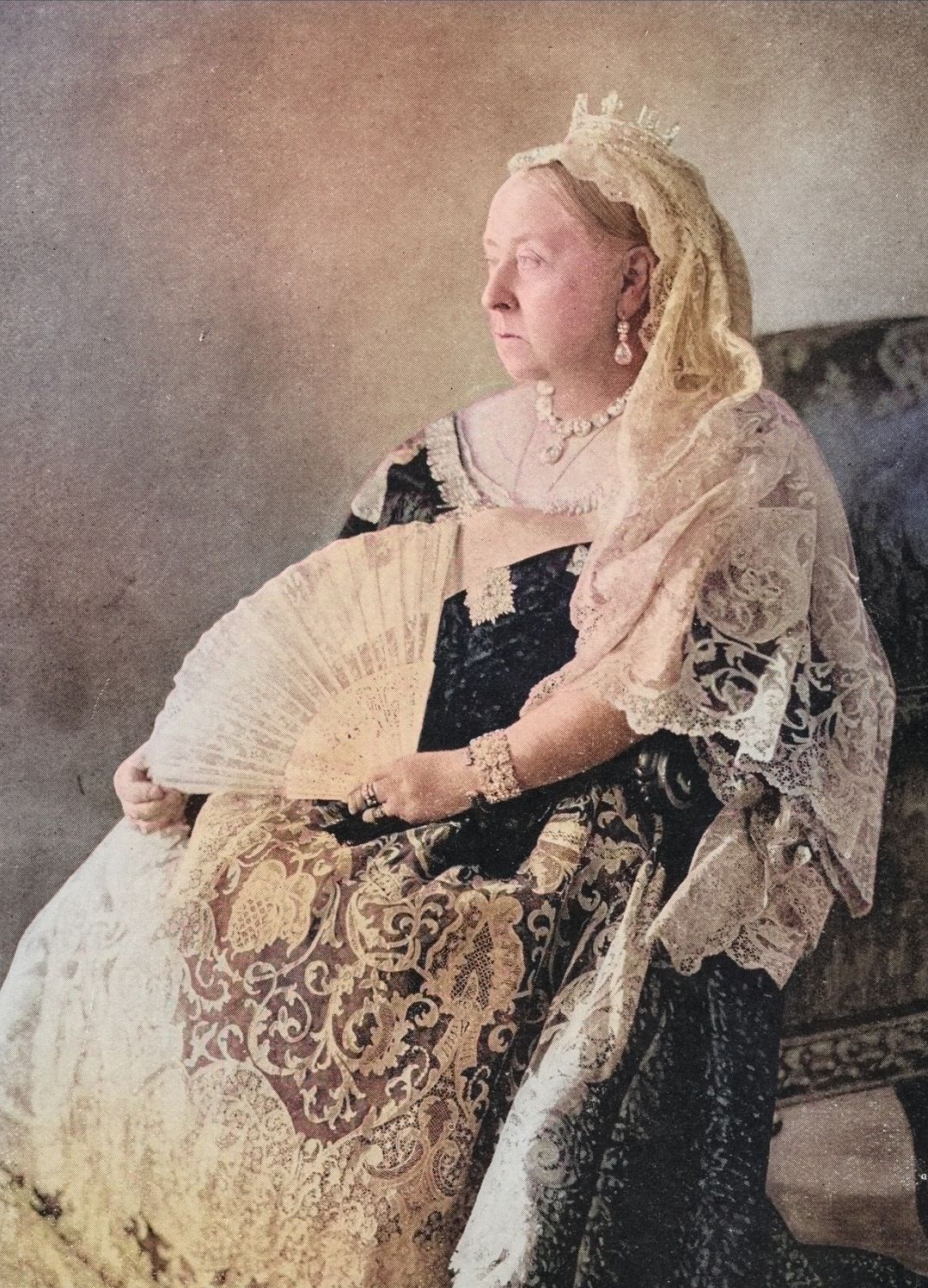 A colourised photograph of Queen Victoria holding a fan