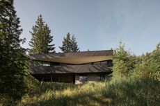 view of Passive House Forest Retreat, a timber structure engulfed in the tree canopy
