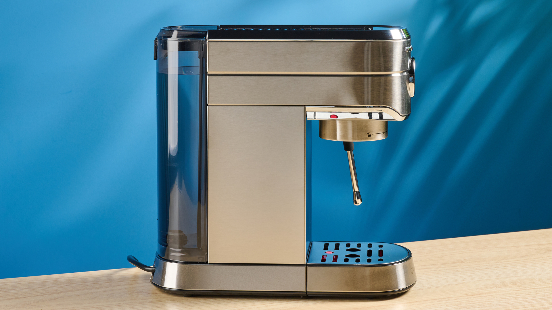 the casabrews cm5418 espresso machine in silver showing its steam wand and water tank and accessories