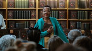 Cheryl (Marianne Jean-Baptiste) speaking to a crowd in The Following Events Are Based On A Pack Of Lies