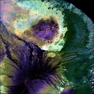 The lava-coated summits of Mauna Loa (bottom) and Mauna Kea (top) are colored deep purple in this false-color Landsat satellite image of Hawaii's Big Island. Along the bottom edge, the crater of Kilauea — the world's most active volcano — is visible as well. Landsat 7's Enhanced Thematic Mapper Plus (ETM+) sensor took this image in January 2001.