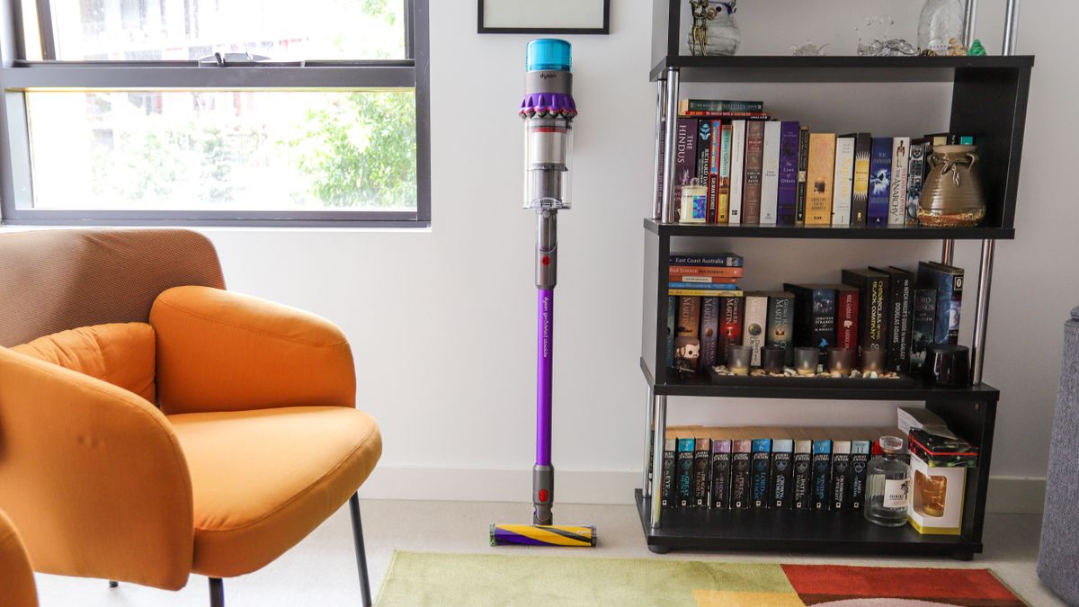 Dyson Gen5 Detect standing beside a bookshelf