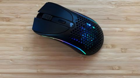 Glorious Model D 2 gaming mouse with RGB lighting on on a wooden desk