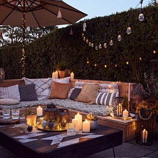 patio at night lit up with candle light and fairy lights