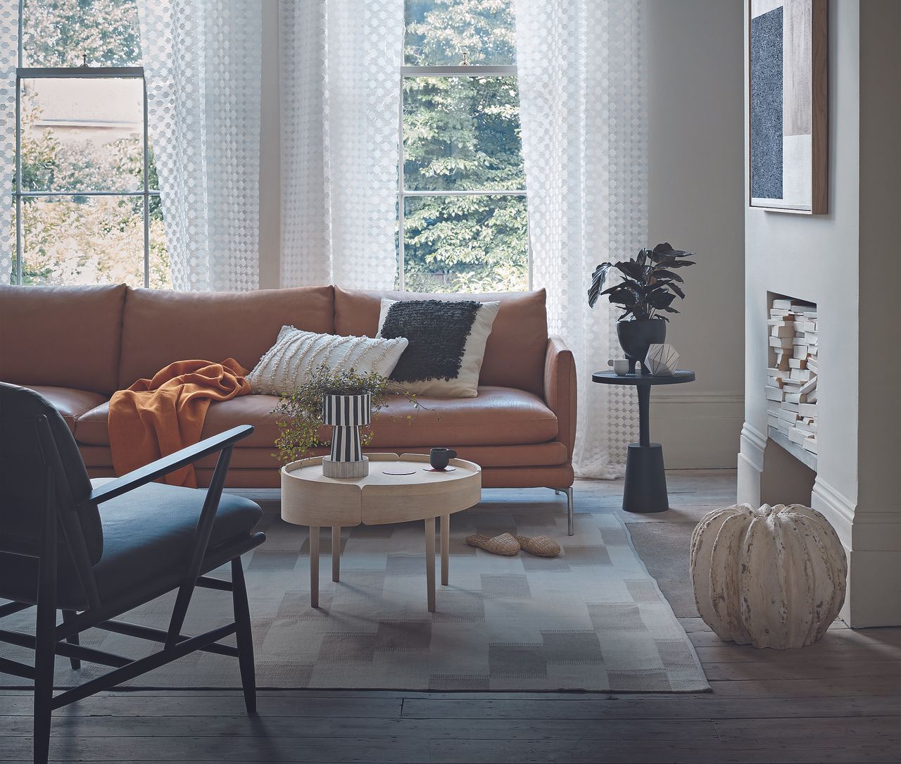 Living room with stripped wooden floorboards, pale grey walls and elaborate coving. 