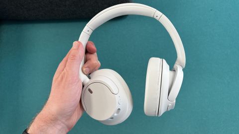 Sony WH-CH720N headphones held in a hand