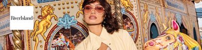 river island logo top left with a wide image of a woman on a carousel 