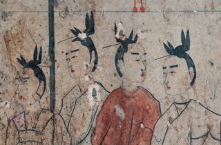 A close-up of four of the female attendants under a parasol. Notice the detail of their "flying bird" hairstyles.