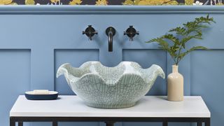 Scalloped-edge sink in blue bathroom