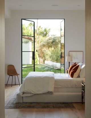 bedroom with white walls steel windows