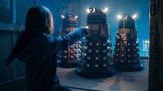The Doctor points her sonic screwdriver at three Daleks in Eve of the Daleks
