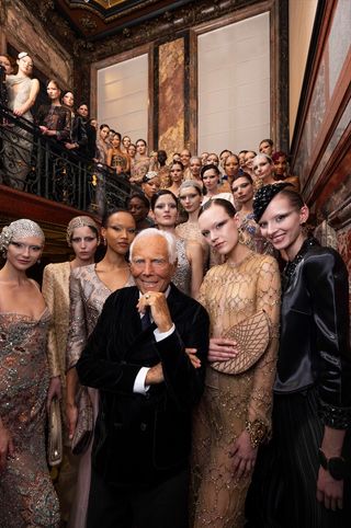 Giorgio Armani at his S/S 2025 Armani Privé show surrounded by models