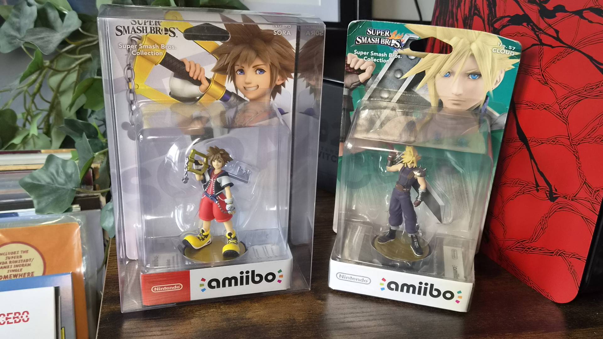 Image of the Sora and Cloud amiibo sitting side by side, one is in a protector and the other is not.