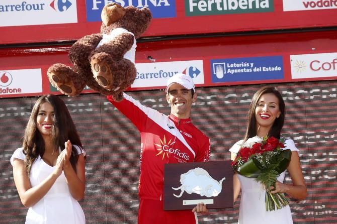 Dani Navarro (Cofidis) holds a bear aloft after winning stage 13 of the Vuelta a Espa&ntilde;a.
