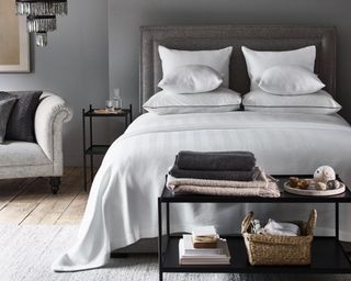 Abingdon Duvet Cover in grey bedroom on bed with black metal bedside table and black metal table at the end of bed