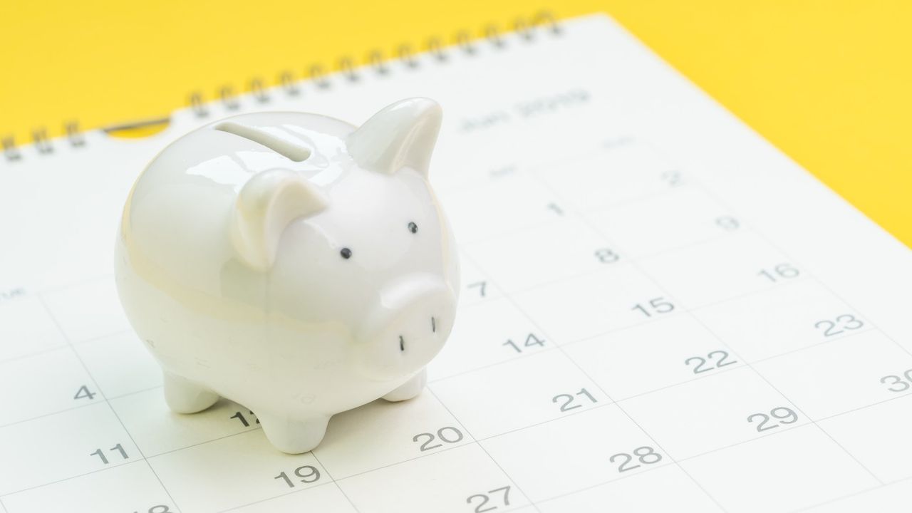 A piggy bank on a calendar