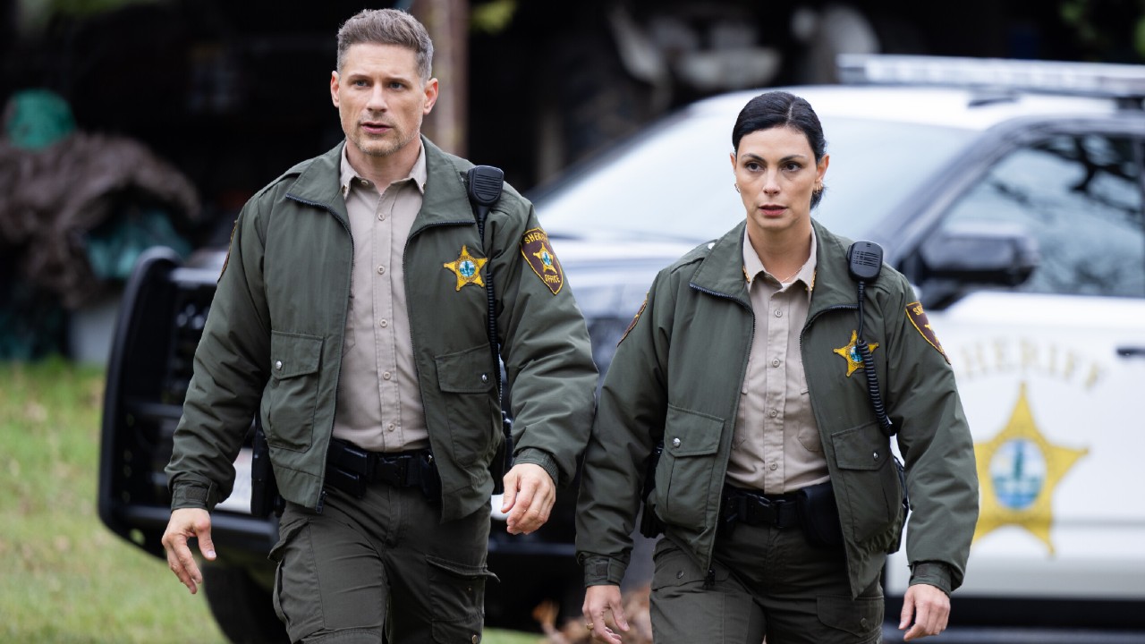 From left to right: Matt Lauria as Boone walking next to Morena Baccarin as Mickey.