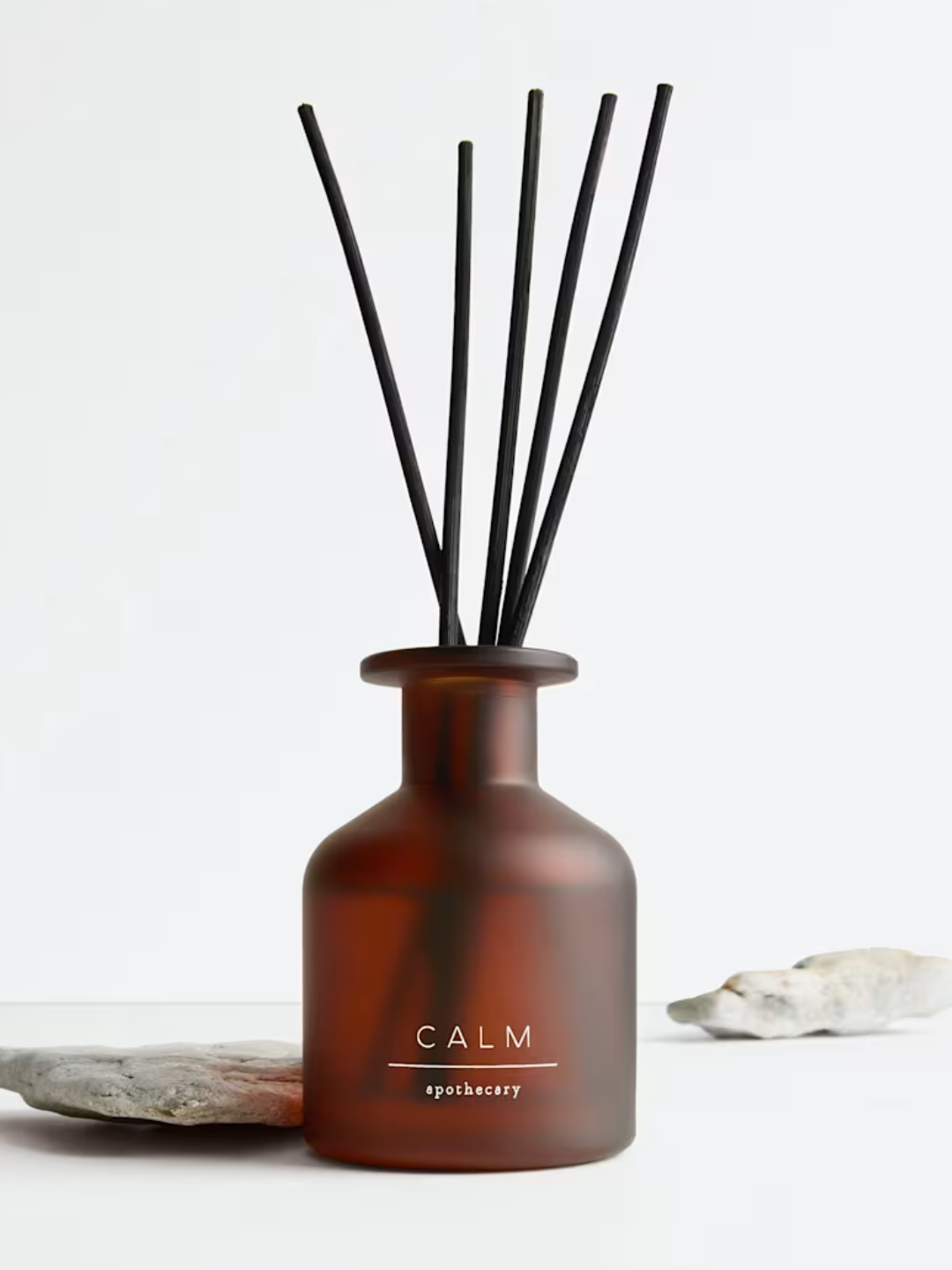 An amber glass diffuser with black reeds from M&amp;amp;S