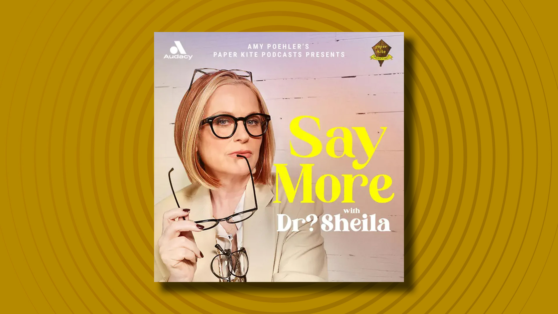 The logo of the Say More with Dr? Shiela podcast on a yellow background