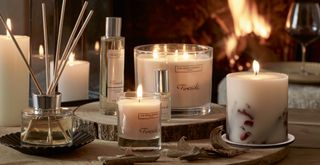 The White Company home scent fireside collection of candles and diffusers photographed beside a roaring fire