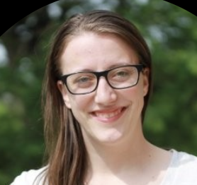 Headshoot of a woman with long, light brown hair with glasses and a white top