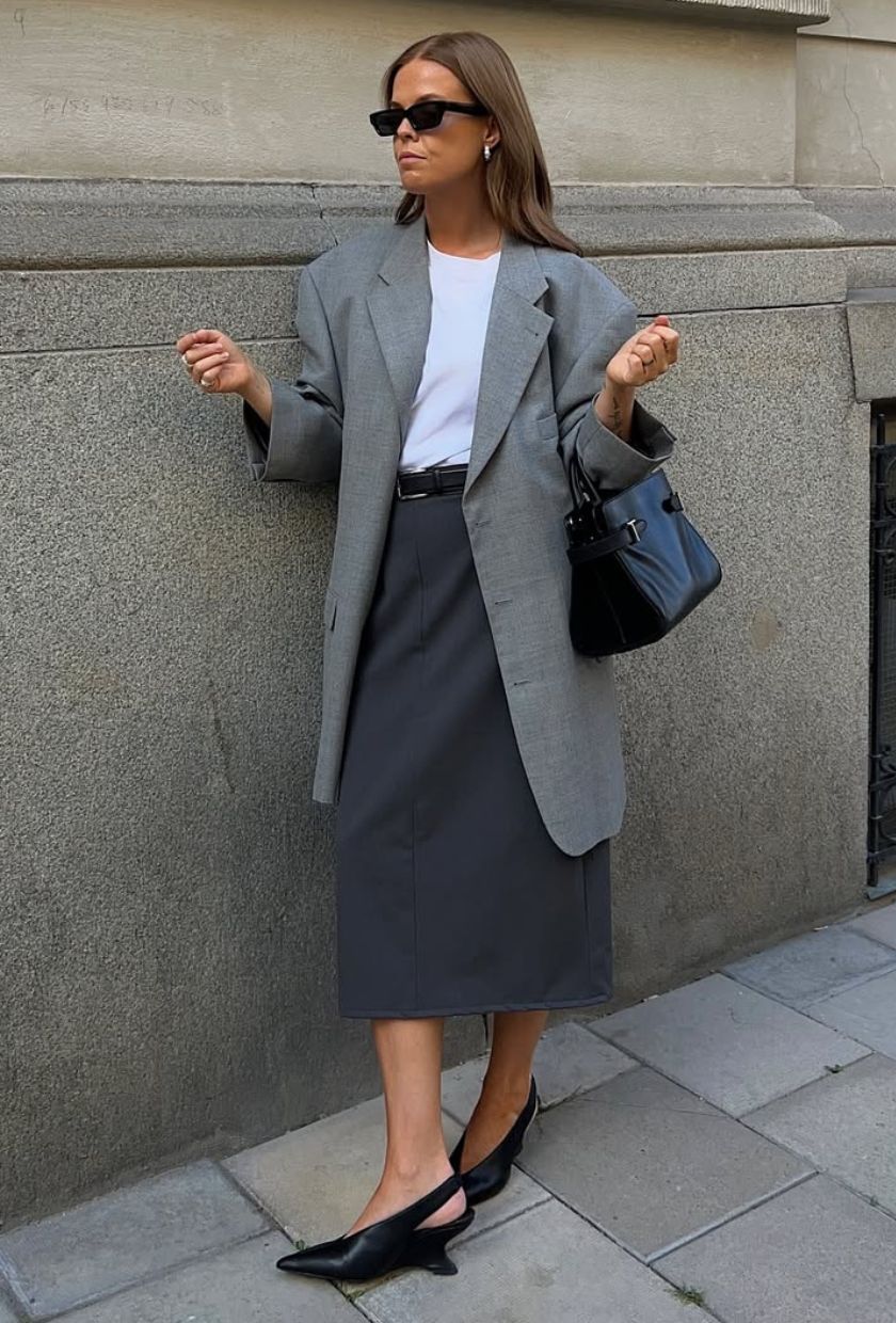 @haaannajohansson wears a grey relaxed blazer, white t-shirt, charcoal pencil skirt, black heels and a handbag