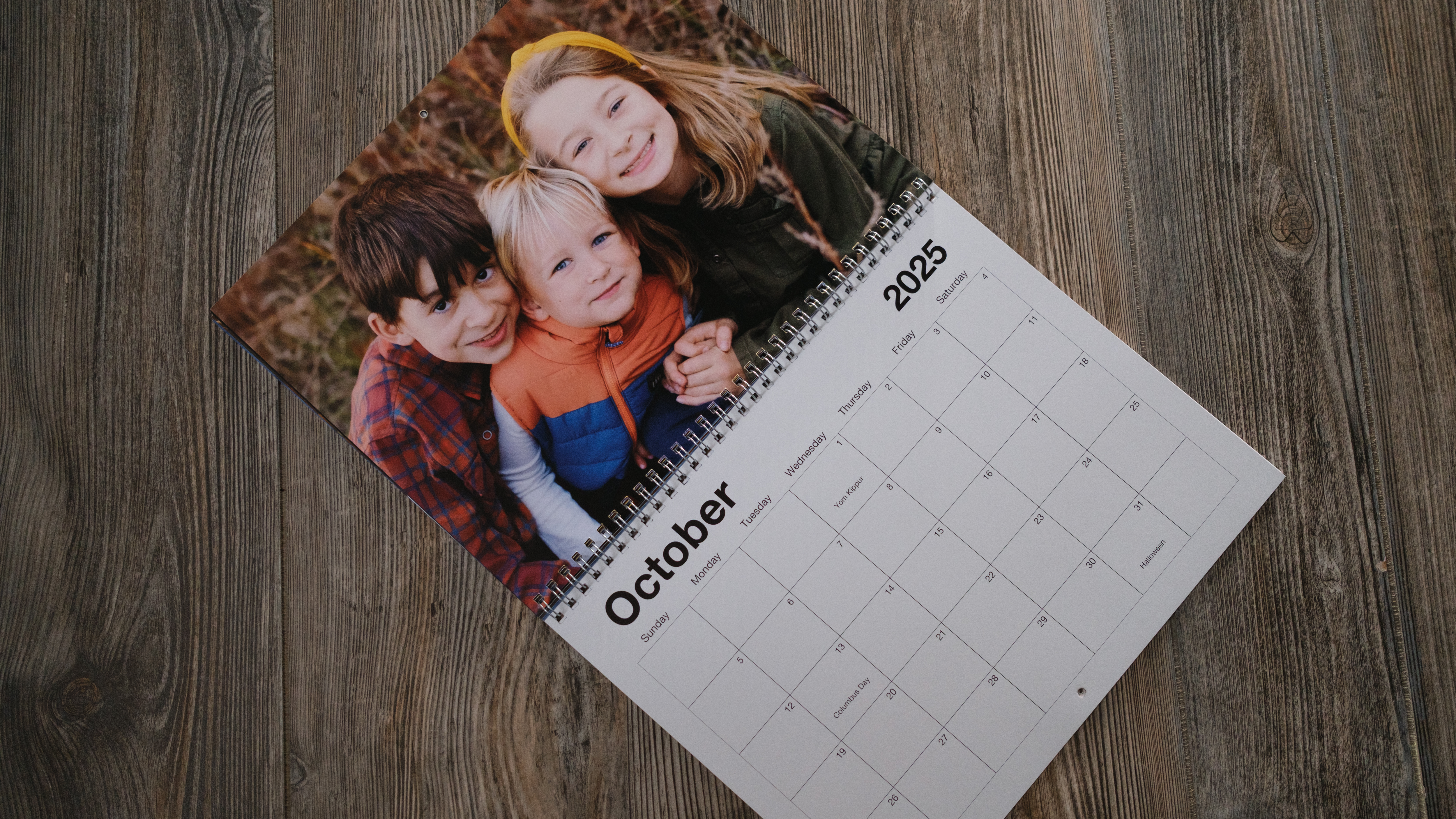 A photo calendar from Shutterfly on a wood background