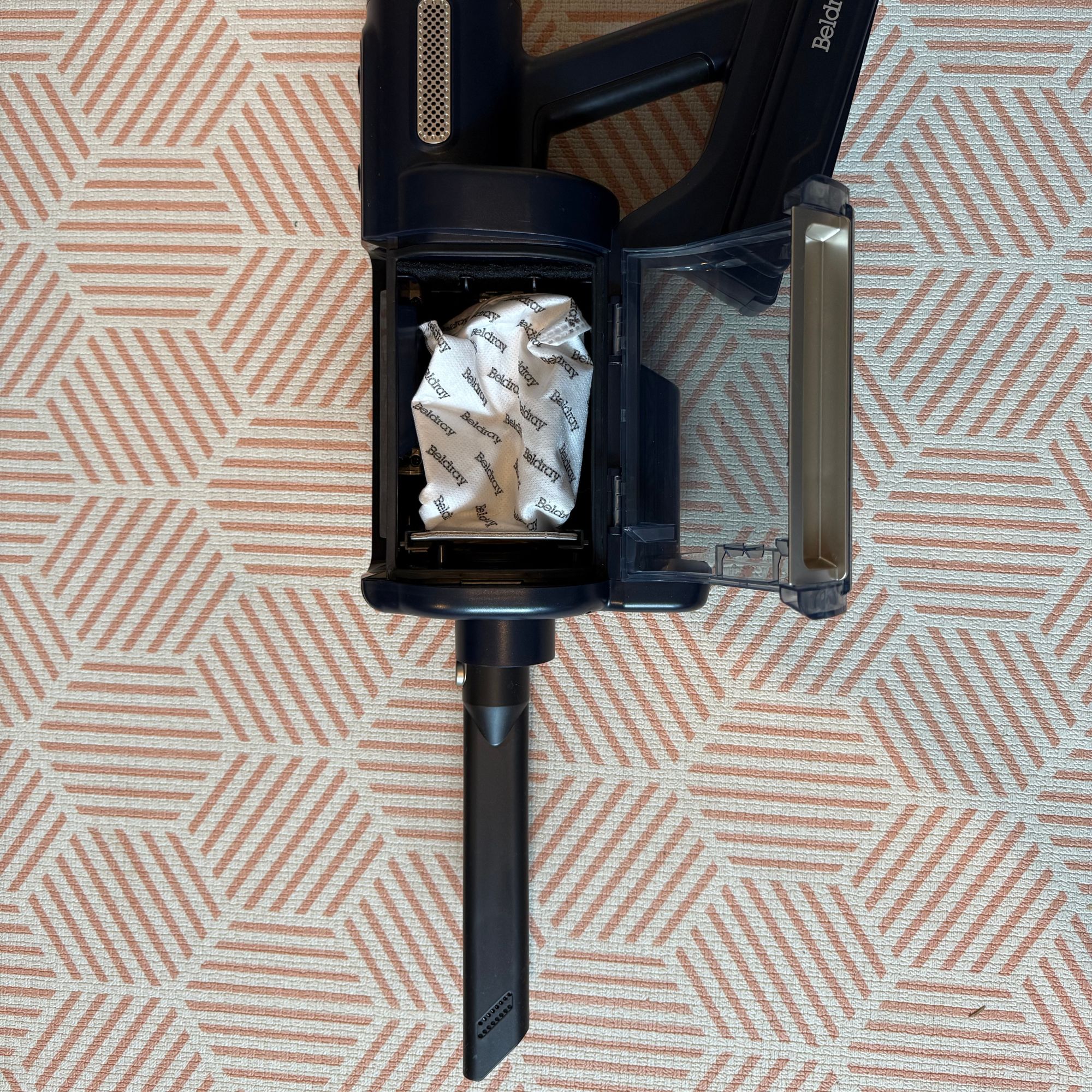 Handheld Beldray Airgo on a white and orange rug