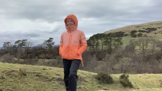 Julia Clarke with her hood up wearing the Norrona Falketind thermo60