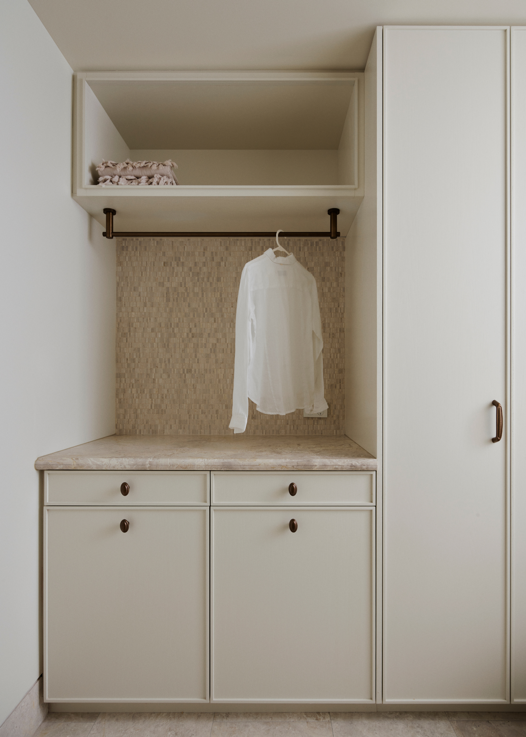 A wardrobe with a hanging rod, a set of drawers and in-built cupboards