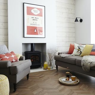 grey sofas, wooden floor, fireplace, woodburner and lots of cushions