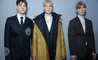 Three male models posing in Dior