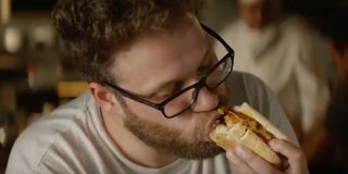 Seth Rogen eating a hot dog