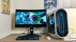 Alienware Aurora R15 review unit on a desk, movie playing onscreen
