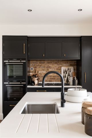 black and white kitchen with black kitchen tap