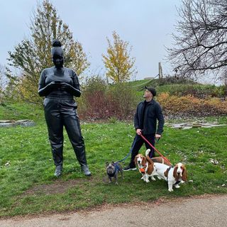 Russell Tovey and his dogs next to a sculptue by Thomas J Price