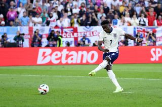 Bukayo Saka of England scores the team's third penalty in the penalty shoot out during the UEFA EURO 2024 quarter-final match between England and Switzerland at Düsseldorf Arena on July 06, 2024 in Dusseldorf, Germany. (Photo by Alex Livesey/Getty Images)