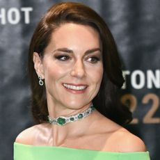 Kate Middleton wears a bright green off-the-shoulder dress with Princess Diana's 20 million dollar choker necklace, while Princess Diana wears a one-shoulder green dress and a tiara